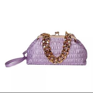Large size women's handbag with gold chunky chain handle.
